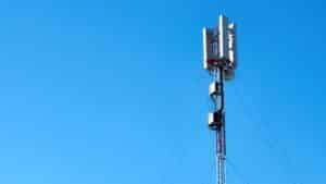 black and white electric post under blue sky during daytime