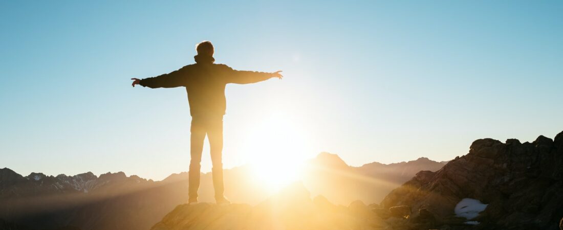 person standing on hill
