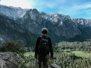 man standing on rock mountain