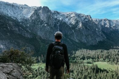 man standing on rock mountain